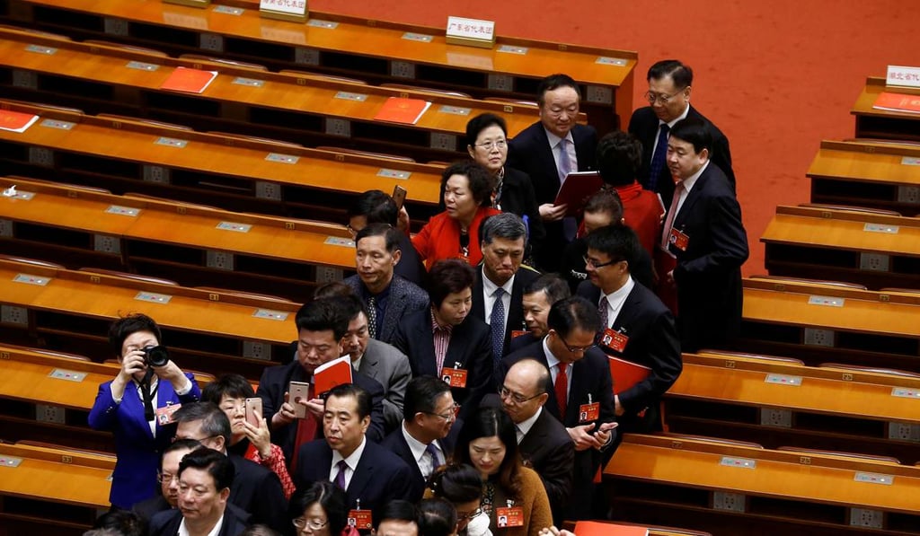 Delegates leave after the closing session of China's National People's Congress at the Great Hall of the People in Beijing on Wednesday. Photo: Reuters