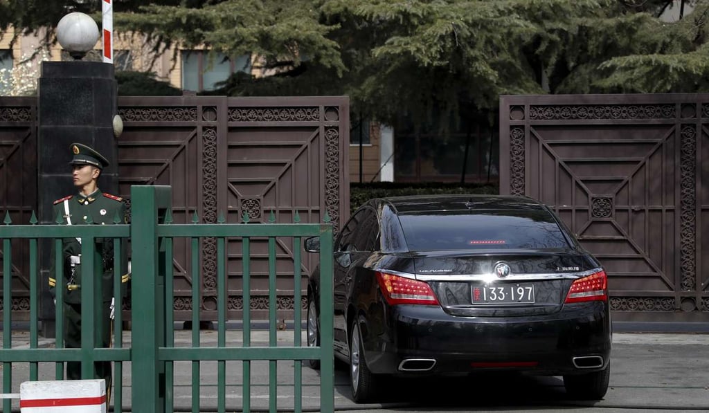 A Chinese paramilitary policeman stands guard as an embassy vehicle drives into the North Korea Embassy in Beijing on Saturday. Photo: AP A Chinese paramilitary policeman stands guard as an embassy vehicle drives into the North Korea Embassy in Beijing on Saturday. Photo: AP