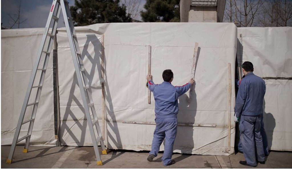 Workers cover a wall with plastic to prepare for maintenance work at a parking area in Beijing. More than 13 million new jobs have been created in China each year since 2013. Many of these are in the service sector, which has been growing faster than the manufacturing, mining and construction sectors. Photo: AFP Workers cover a wall with plastic to prepare for maintenance work at a parking area in Beijing. More than 13 million new jobs have been created in China each year since 2013. Many of these are in the service sector, which has been growing faster than the manufacturing, mining and construction sectors. Photo: AFP