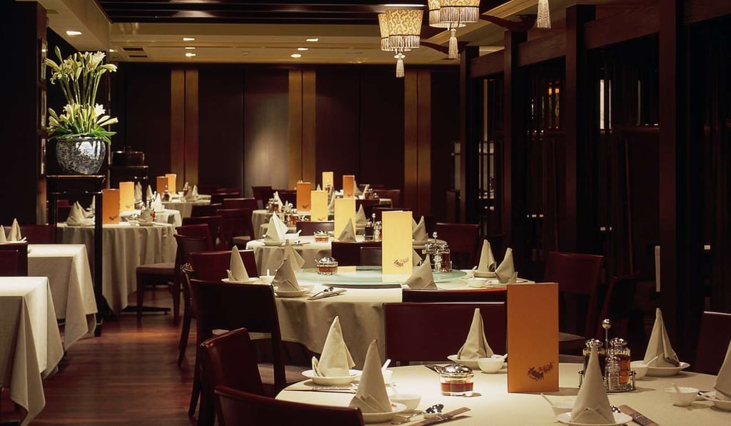 The décor at Yè Shanghai is elegant, in dark wood, and windows look out across Tsim Sha Tsui.