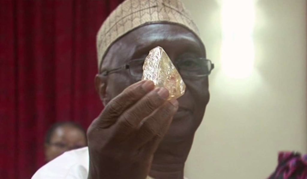 In this photo taken from video footage, Sierra Leone's Minister of Mines and Mineral Resources Alhaji Minkailu Mansaray admires the 706-carat diamond during a meeting with delegates of Kono district at the presidential office in Freetown. Photo: AP In this photo taken from video footage, Sierra Leone's Minister of Mines and Mineral Resources Alhaji Minkailu Mansaray admires the 706-carat diamond during a meeting with delegates of Kono district at the presidential office in Freetown. Photo: AP