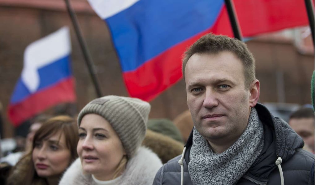 Russian opposition leader Alexei Navalny and his wife Yulia, second right, take part in a march in memory of opposition leader Boris Nemtsov in Moscow, Russia, in 2015. Photo: AP