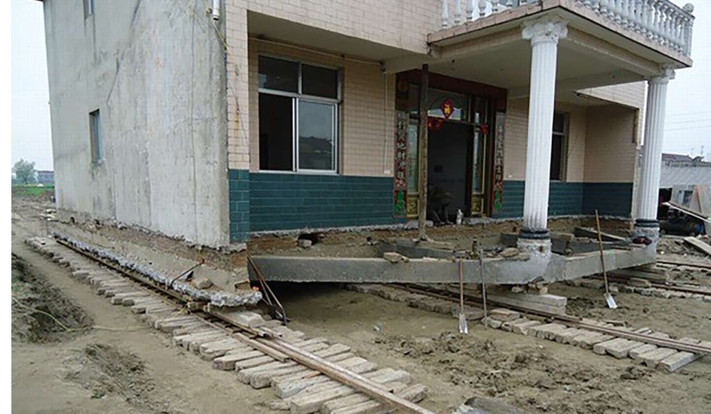 The home was jacked up and hauled on skates of steel tubes across wooden sleepers. Photo: Handout