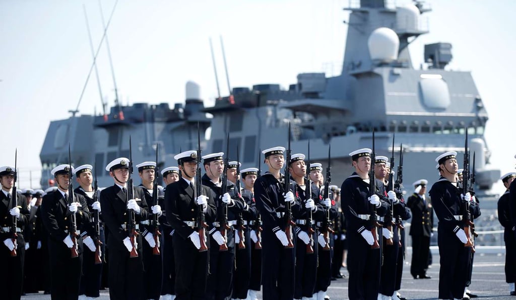 Members of the Japan Maritime Self-Defence Force attend a handover ceremony for the helicopter carrier Kaga in Yokohama. Photo: Reuters
