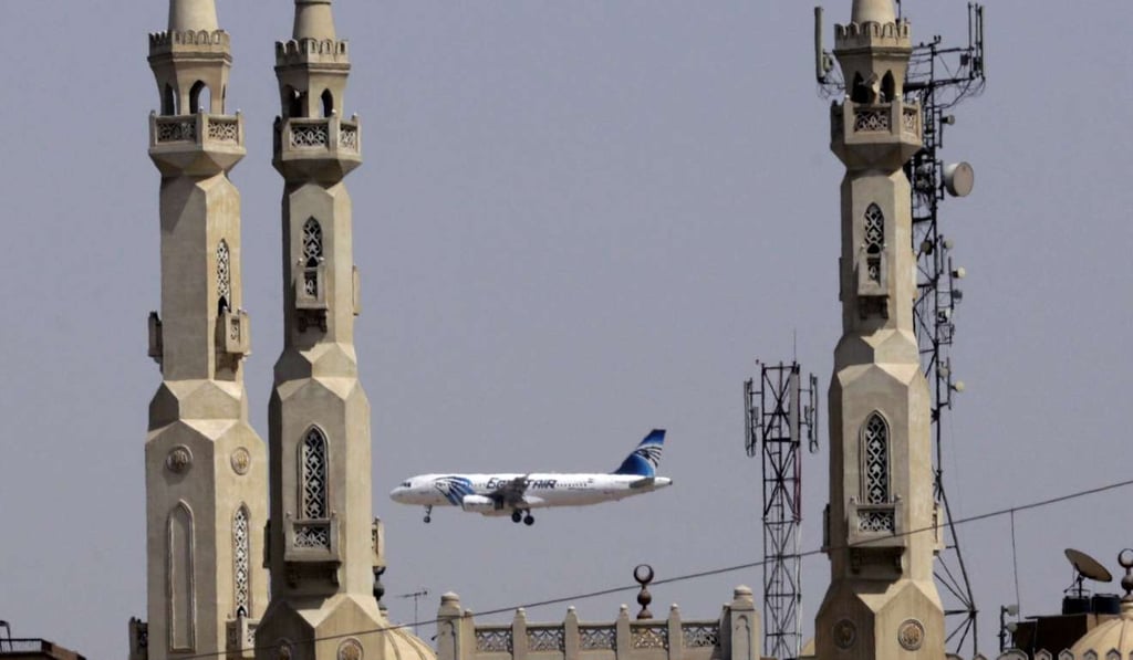 An EgyptAir plane flies past minarets of a mosque as it approaches Cairo International Airport, in Cairo, Egypt. A new US security measure targeting flights from eight mostly Muslim countries is leading travelLers to reconsider their plans to fly through some airports in the Middle East. Photo: AP An EgyptAir plane flies past minarets of a mosque as it approaches Cairo International Airport, in Cairo, Egypt. A new US security measure targeting flights from eight mostly Muslim countries is leading travelLers to reconsider their plans to fly through some airports in the Middle East. Photo: AP