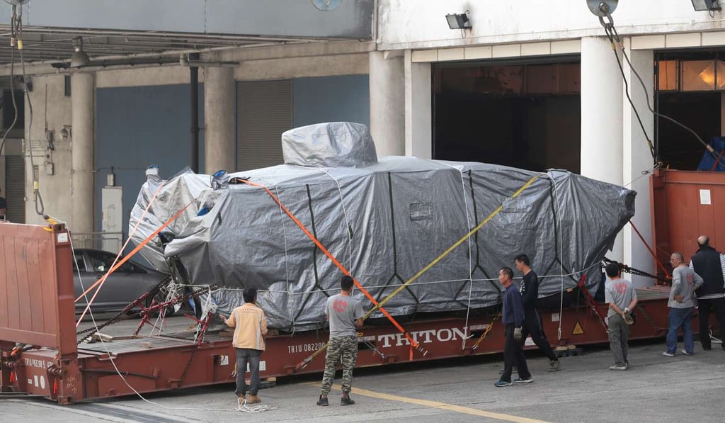 One of the Singaporean military vehicles is moved out of the customs' cargo examination compound in Tuen Mun. Photo: Edward Wong