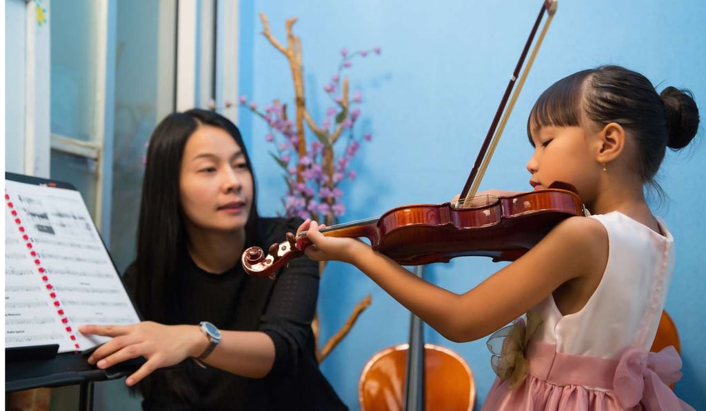 A violin student takes her tuition seriously. A violin student takes her tuition seriously.