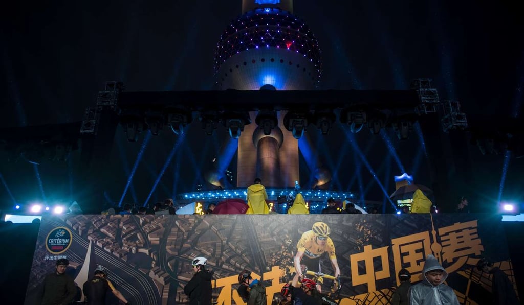 Cyclists wait in front of the Shanghai Pearl Tower during an event promoting the Tour de France. Photo: AFP Cyclists wait in front of the Shanghai Pearl Tower during an event promoting the Tour de France. Photo: AFP