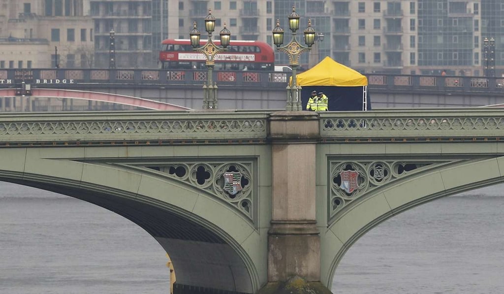 Police officers and forensics investigators work on Westminster Bridge, London, the morning after an attack by a man driving a car and wielding a knife left three people dead and dozens injured. Photo: Reuters