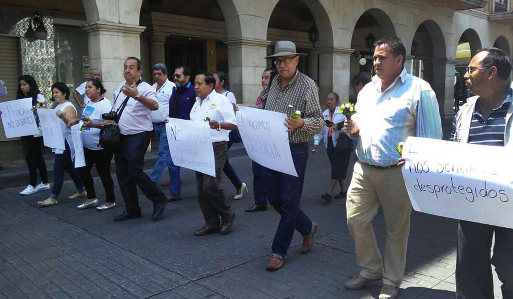 Journalists from the Mexican state of Veracruz participate in a silent march to protest the murder of columnist Ricardo Monlui in Veracruz, Mexico, while another journalist was shot dead on Thursday from La Jornada. Photo: EPA