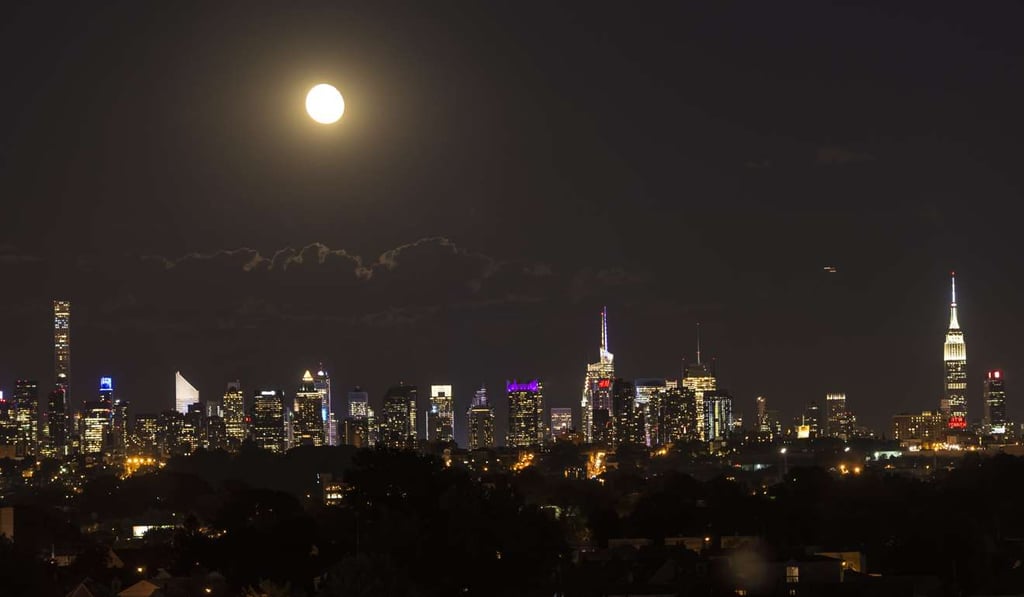 The moon rising above the Manhattan skyline in New York. For the eleventh year on March 25, 2017, cities will turn their lights off for Earth Hour. Photo: AFP