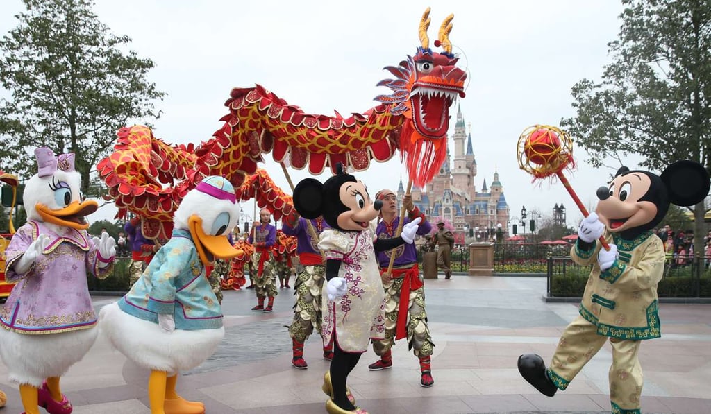 Cartoon characters join in the Chinese traditional dragon dance in the Shanghai Disney Resort. Photo: Xinhua