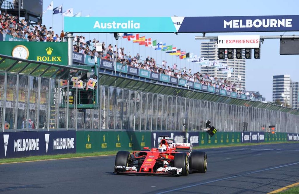 Vettel crosses the line to take the chequered flag. Photo: AFP