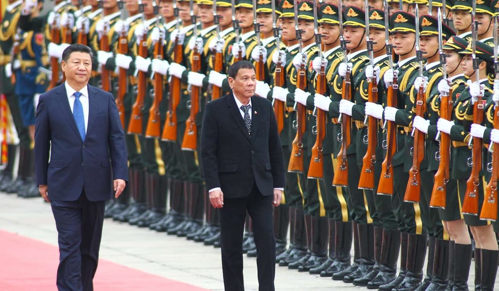 President Xi Jinping, left, and Philippine President Rodrigo Duterte view an honour guard in Beijing in October. Photo: Simon Song
