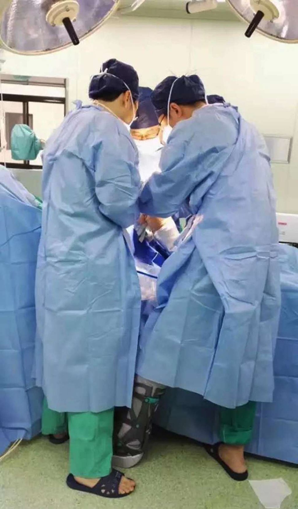 Chen, with leg in orthosis, and his colleagues perform an operation. Photo: Handout