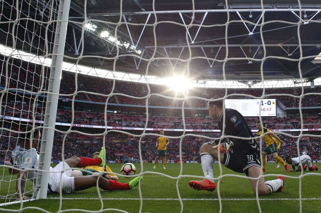 Lithuania goalkeeper Ernestas Setkus makes a save from Raheem Sterling. Photo: AFP