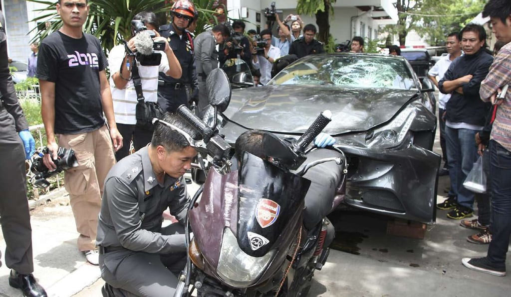 A Ferrari, that was driven by Vorayuth Yoovidhya, a grandson of late Red Bull founder Chaleo Yoovidhya, and a motorcycle, both involved in an accident, are displayed by police in Bangkok, File photo: AP