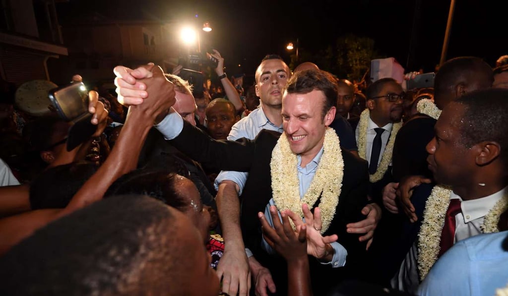 French presidential election candidate for the En Marche! movement Emmanuel Macron is greeted upon his arrival in Dzaoudzi, on the French Indian Ocean island of Mayotte, on Sunday. Photo: AFP