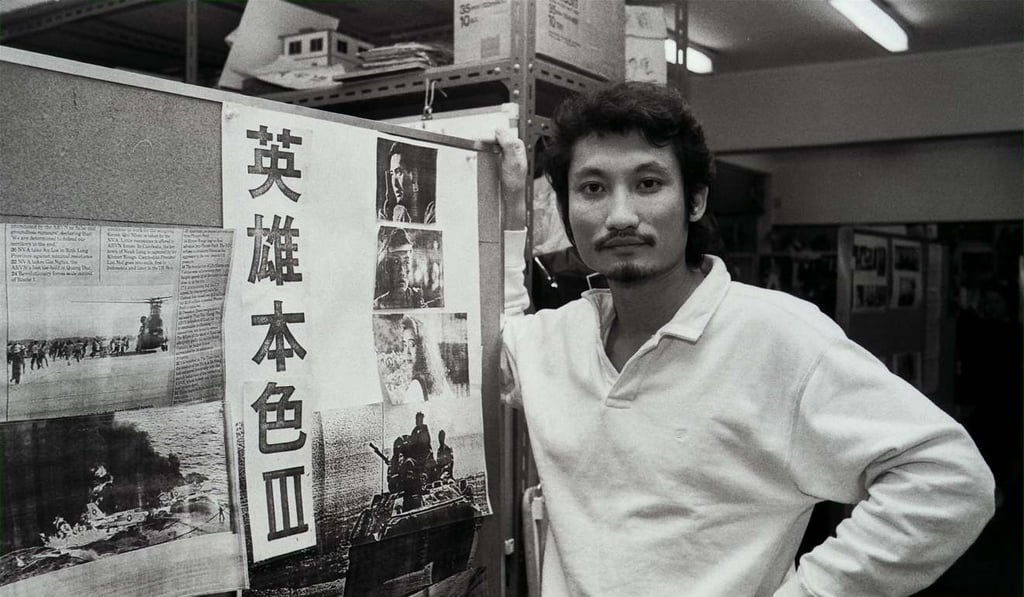 Tsui Hark poses next to a poster advertising 1989 film A Better Tomorrow III, starring Chow Yun-fat and Anita Mui. Photo: SCMP
