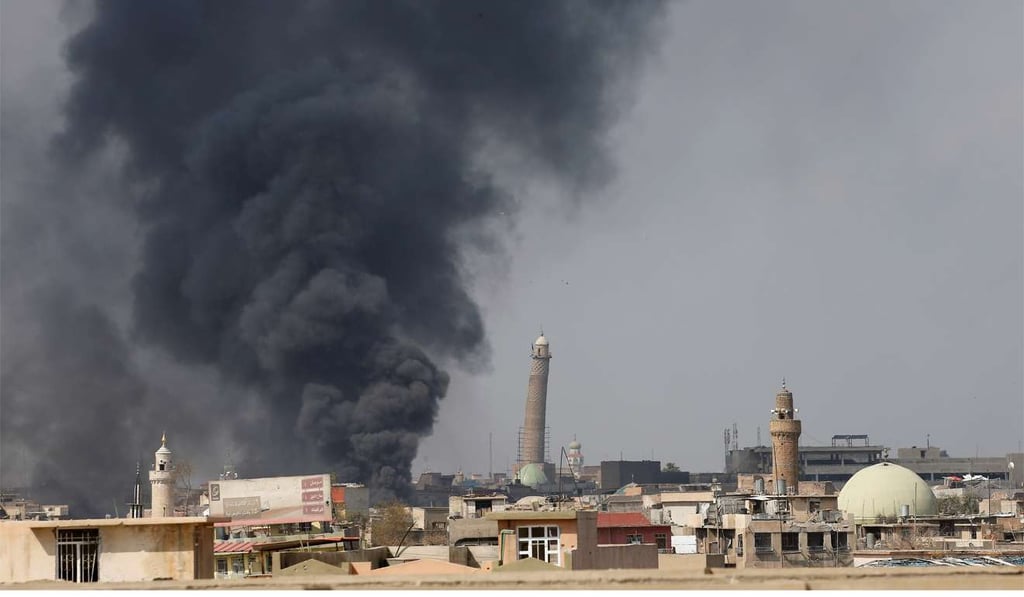 Smoke rises from the scene of an air strike in Mosul on March 17. Photo: Reuters