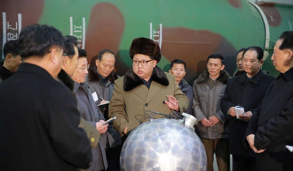 North Korean leader Kim Jong-un, centre, talks with nuclear scientists and technicians. Photo: EPA
