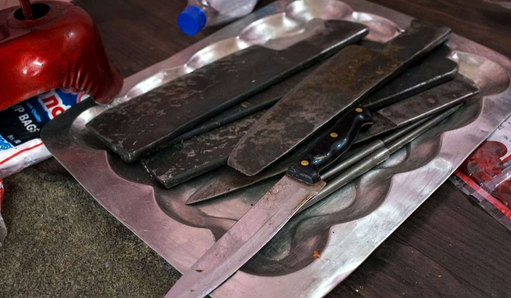 Unused knifes are kept on a tray in an empty butcher shop in the old quarters of Meerut. Photo: AFP