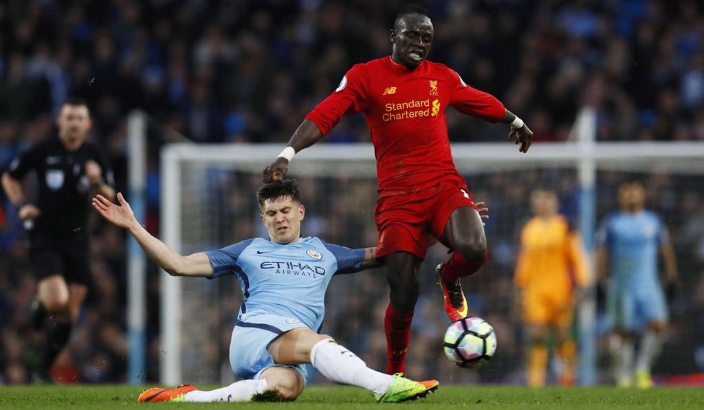 Liverpool's Sadio Mane (right) in action with Manchester City's John Stones. Photo: Reuters