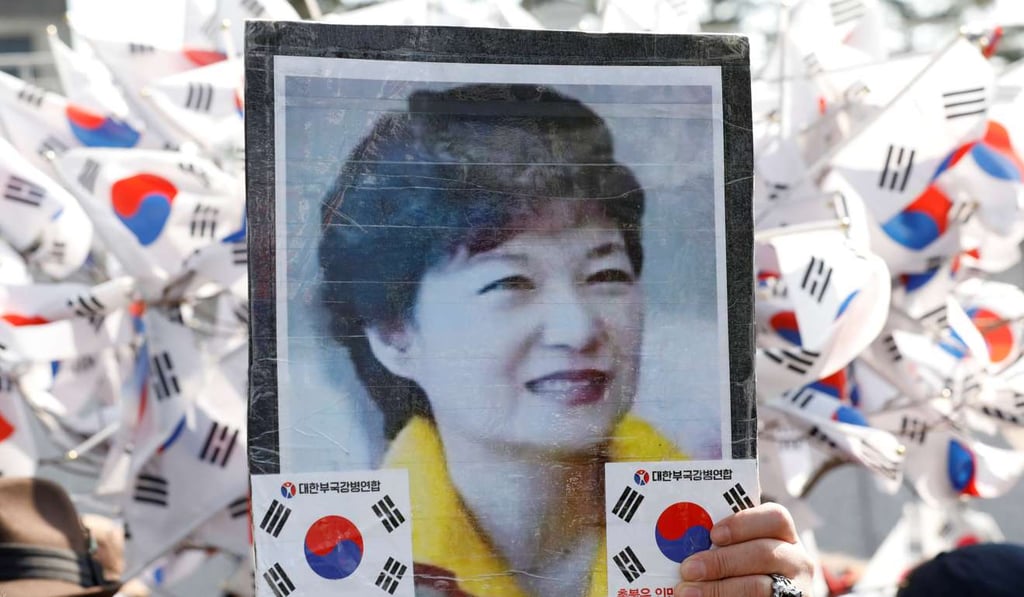 A supporter holds a portrait of South Korea’s ousted leader Park Geun-hye in Seoul. Photo: Reuters