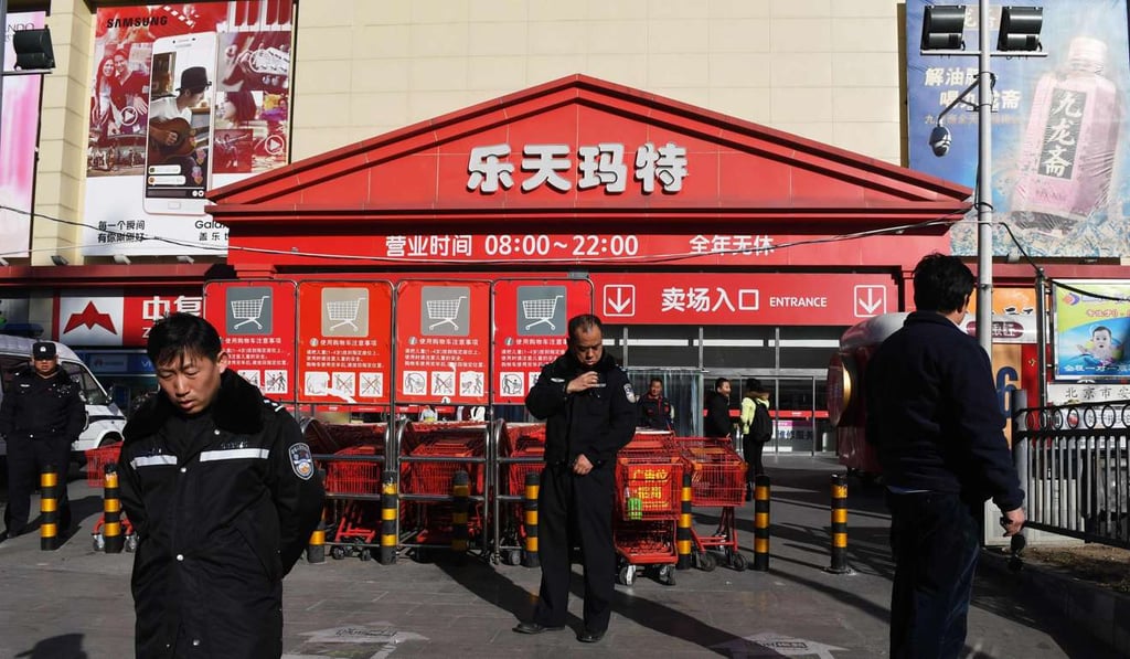 Policemen patrol outside a Lotte Mart in Beijing. Chinese protesters have targeted the company for its decision to give land to the South Korean government for the deployment of THAAD. Photo: AFP