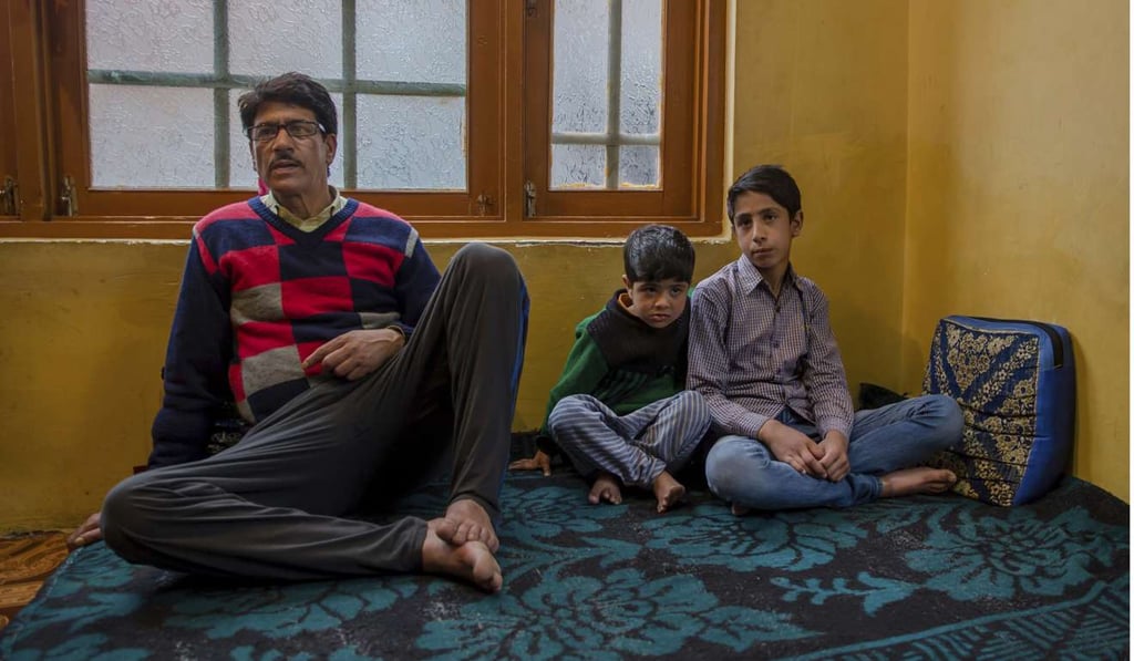 Eleven-year-old Mir Mehran (right) with his cousin Saiba Mir (centre) and his father Mohammed Qayoom Mir. Photo: AP