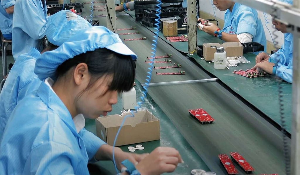 Workers on an electronics production line, from Death by Design. Photo: Handout Workers on an electronics production line, from Death by Design. Photo: Handout