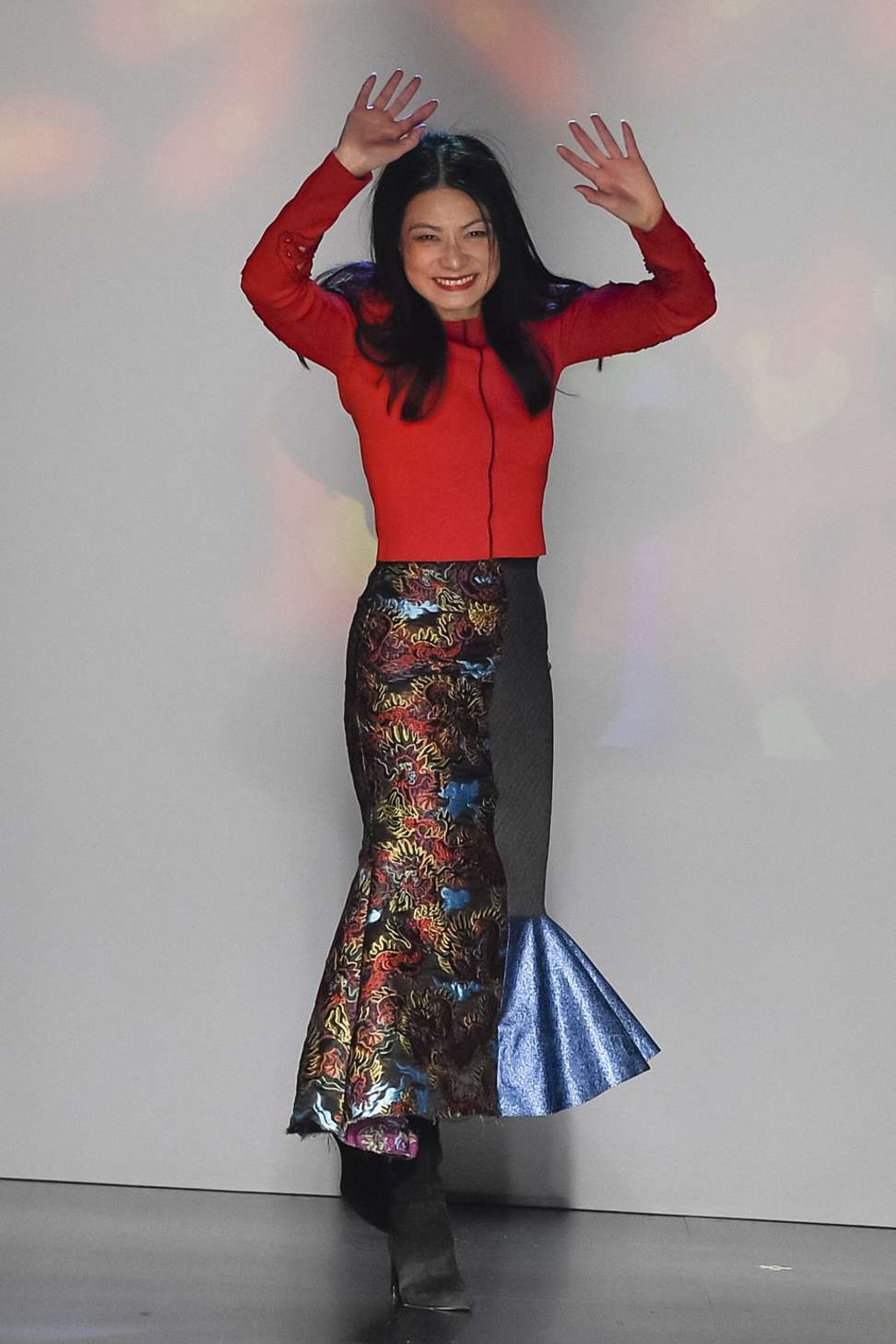Vivienne Tam greets her audience at the end of the New York catwalk show for her autumn-winter collection in February.