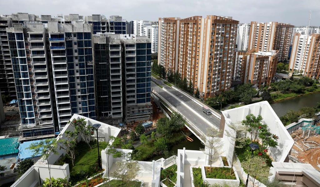 Construction of private housing is seen next to a public housing estate in Singapore. Home ownership is high in Singapore, compared to Hong Kong. Some 91 per cent of residents in Singapore own their homes, while only about 50 per cent of Hong Kong households own their property. Photo: Reuters