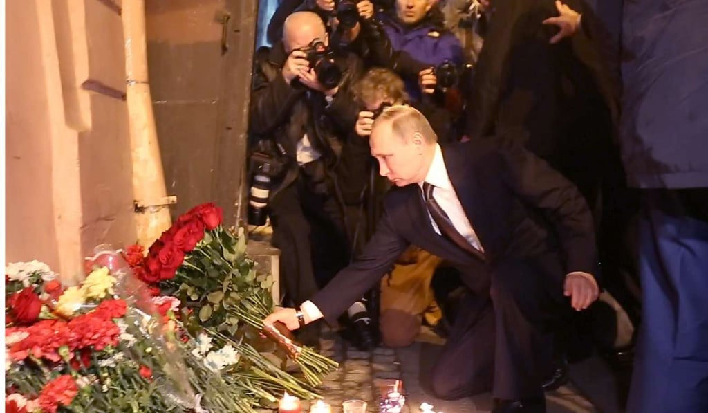 Russian President Vladimir Putin places flowers in memory of victims of the blast in the Saint Petersburg metro outside Technological Institute station on Monday. Photo: AFP