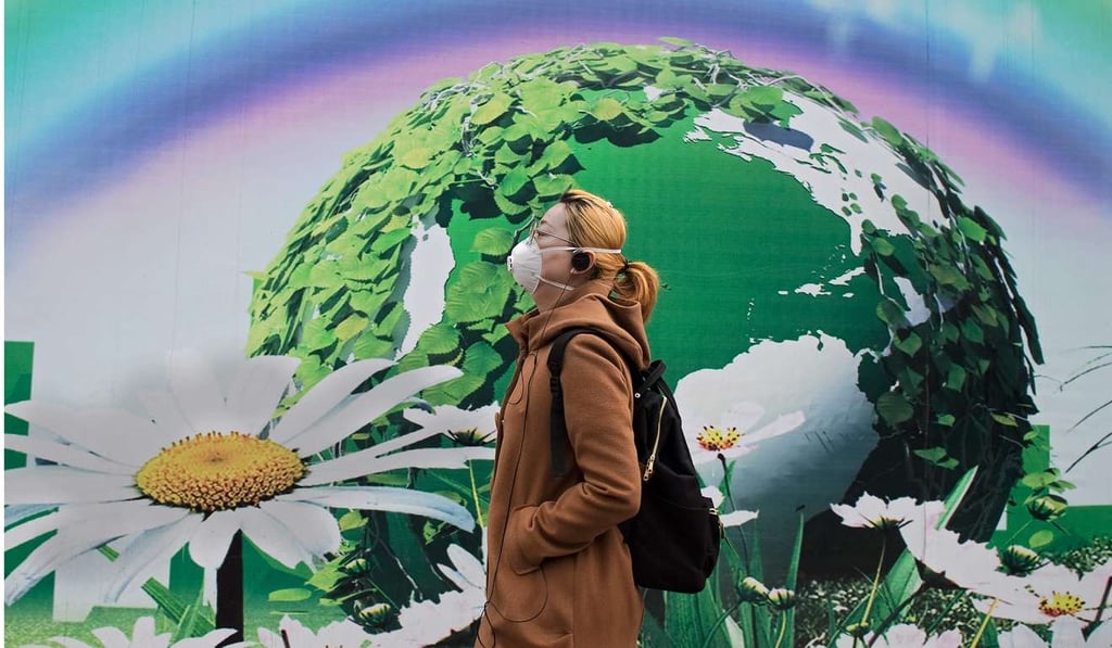 A woman wearing a protective mask walks past a billboard in Beijing in March. China may be fairly described as enjoying unfair cost advantages, with its poor pollution controls and worker rights protection. With development, however, these social costs are becoming increasingly unacceptable. Photo: AFP A woman wearing a protective mask walks past a billboard in Beijing in March. China may be fairly described as enjoying unfair cost advantages, with its poor pollution controls and worker rights protection. With development, however, these social costs are becoming increasingly unacceptable. Photo: AFP