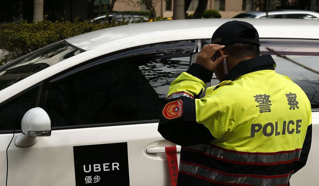 A police officer helps direct traffic during a protest calling for the legalisation Uber in Taipei on 10 February 2017. Photo: EPA