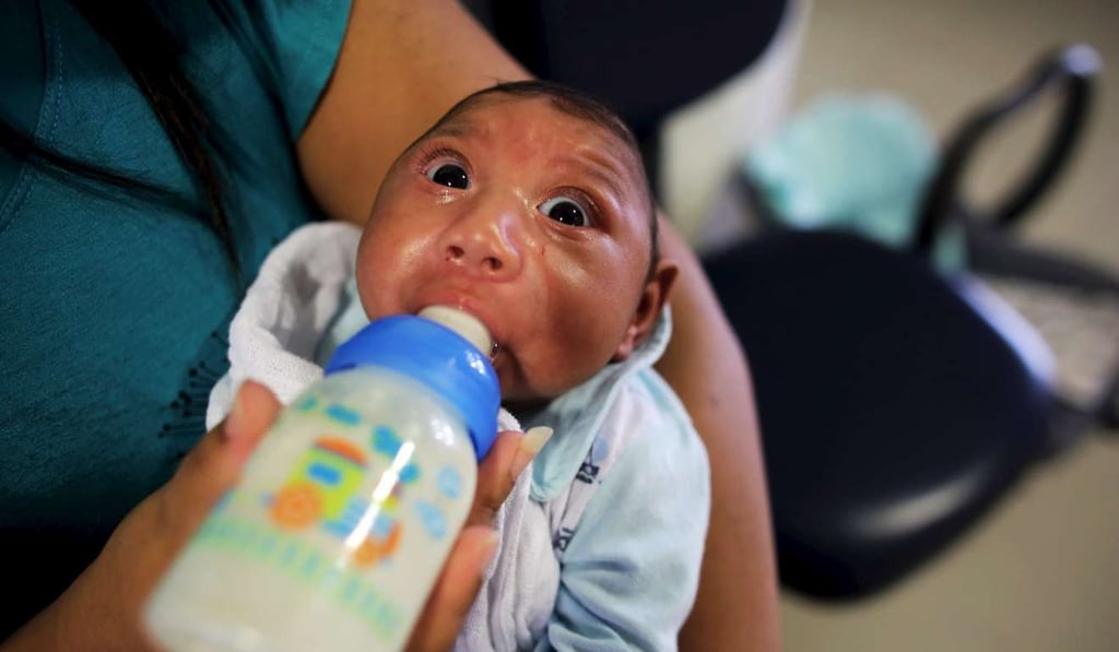 Jackeline, 30, feeds her son Gustavo Henrique who is two-months old and born with microcephaly, in Recife, Brazil. Photo: Reuters