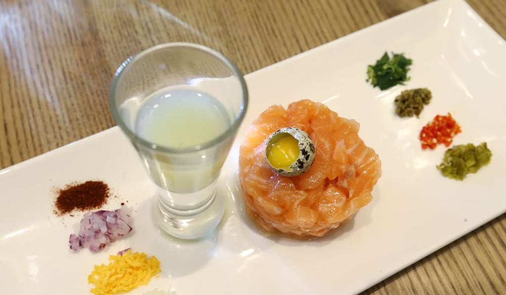 Tartar of salmon, traditional garnishes, smoked paprika and quail's egg. Photo: Dickson Lee