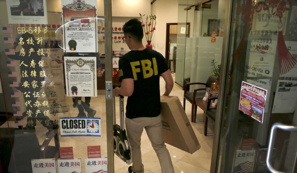 Federal agents raid an office in San Gabriel, Calif. on Wednesday, April 5, 2017. Immigration and FBI agents Wednesday raided the San Gabriel Valley homes and offices of people targeted in a large-scale visa and financial fraud investigation. Photo: Los Angeles Times/TNS Federal agents raid an office in San Gabriel, Calif. on Wednesday, April 5, 2017. Immigration and FBI agents Wednesday raided the San Gabriel Valley homes and offices of people targeted in a large-scale visa and financial fraud investigation. Photo: Los Angeles Times/TNS