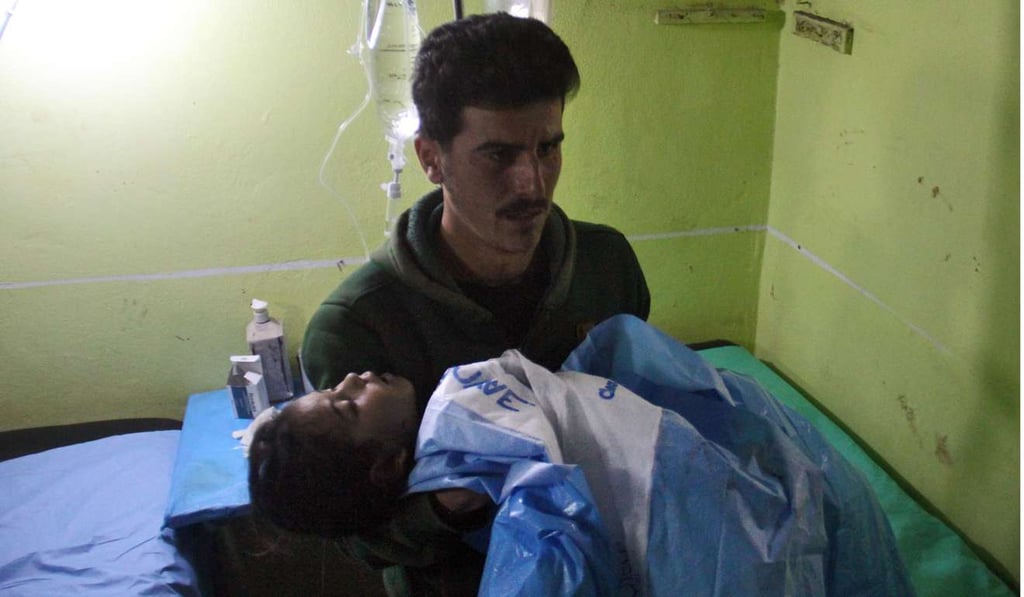 An unconscious Syrian child is carried at a hospital in Khan Sheikhun, a rebel-held town in the northwestern Syrian Idlib province, following a suspected toxic gas attack on Tuesday. Photo: AFP