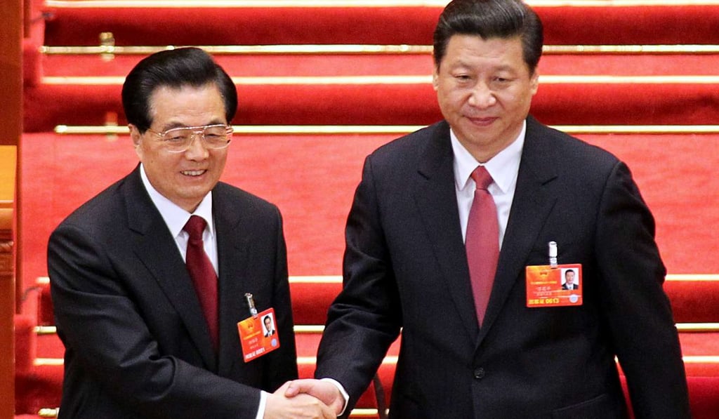 Former Central Military Committee Chairman Hu Jintao, left, congratulates Xi Jinping being elected as the new chairman at the NPC meeting. Photo: Simon Song