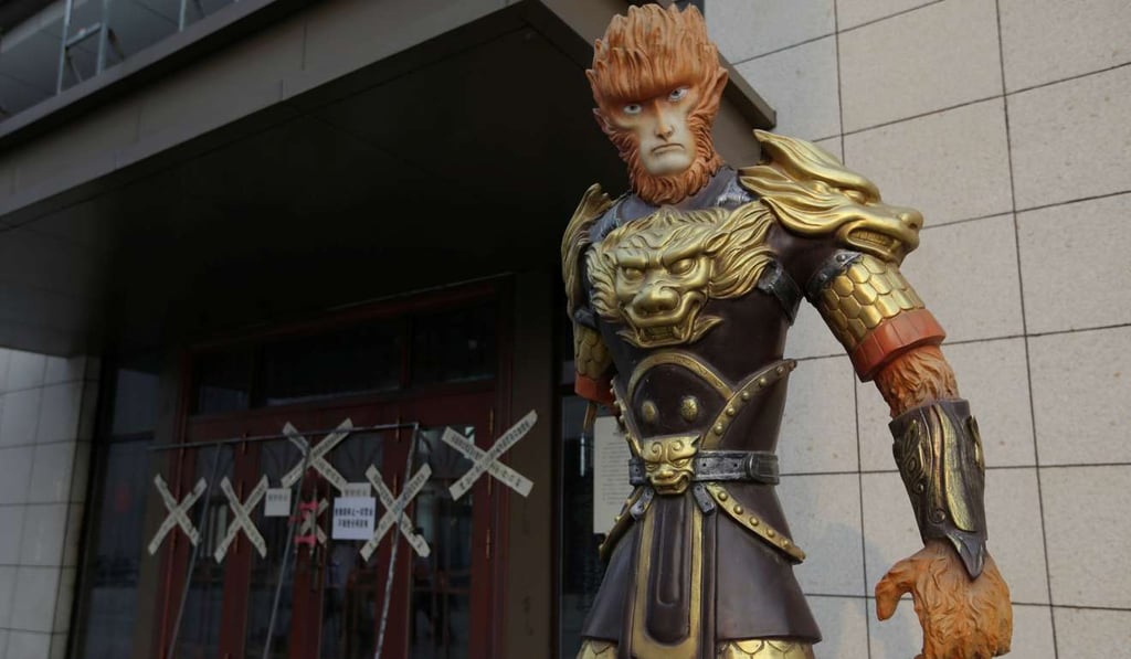 A sculpture of Monkey King, also known as Sun Wukong, is seen next to a closed sales office of a property firm. Photo: Reuters
