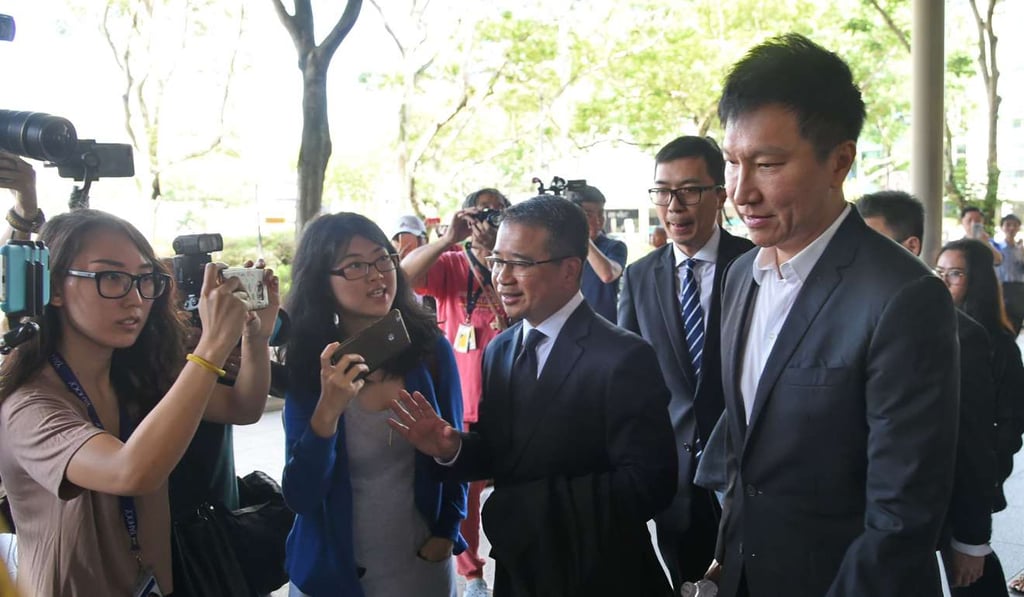 Kong Hee (right), the senior pastor of the City Harvest Church leaving the Supreme Court in Singapore on April 7, 2017. Photo: AFP