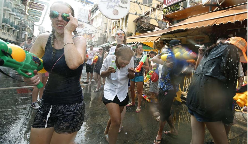 Tourists spray each other with water in the tourist strip of Khao San Road, on the first day of the Songkran festival in 2016. The military junta has called on attendees to avoid skimpy outfits this year. Photo: EPA