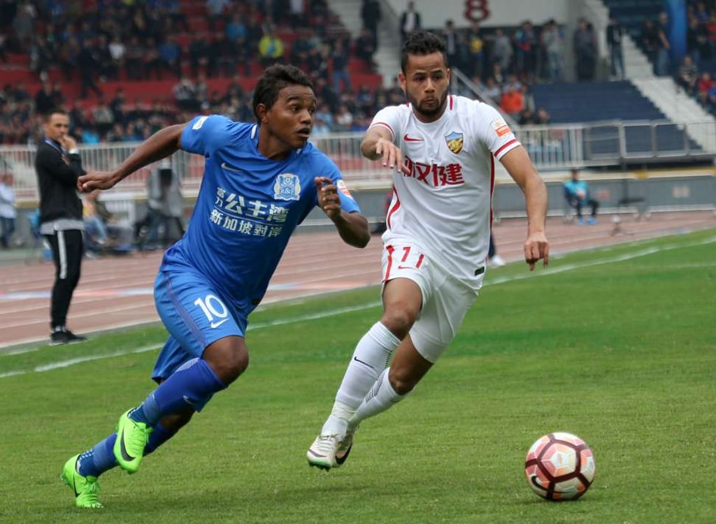 Guangzhou R&F’s Renatinho (left) in action against Tianjian Quanjian. Photo: Xinhua