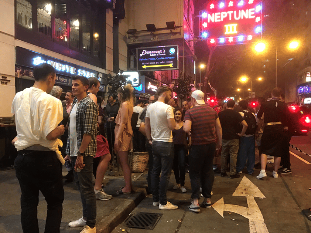 Roadside revellers flow into oncoming traffic outside White Stag. Roadside revellers flow into oncoming traffic outside White Stag.