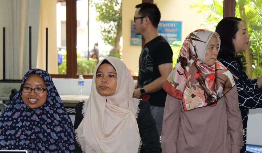 Jamilah, centre wearing brown hijab, is one of many Indonesian maids in Singapore who joined the free eight-week coding course provided by the Creative Economy Agency. Handout photo Jamilah, centre wearing brown hijab, is one of many Indonesian maids in Singapore who joined the free eight-week coding course provided by the Creative Economy Agency. Handout photo