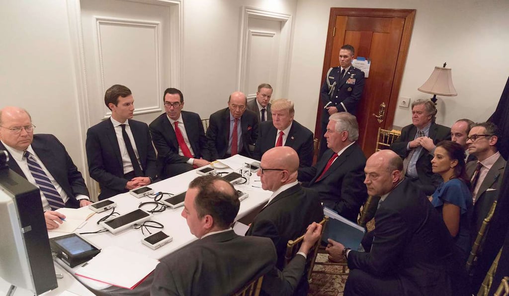 US President Donald Trump (centre) receives a briefing on the Syria military strike from his National Security team via video teleconference on Thursday at the Mar a Lago estate in West Palm Beach, Florida. US Secretary of State Rex Tillerson (centre right) is seated next to Trump. Photo: AFP US President Donald Trump (centre) receives a briefing on the Syria military strike from his National Security team via video teleconference on Thursday at the Mar a Lago estate in West Palm Beach, Florida. US Secretary of State Rex Tillerson (centre right) is seated next to Trump. Photo: AFP