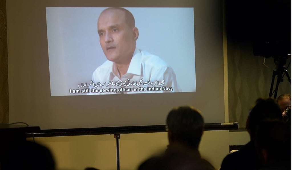 Journalists watch a video of Indian naval officer Kulbhushan Jadhav after his arrest in March 2016. Photo: AFP