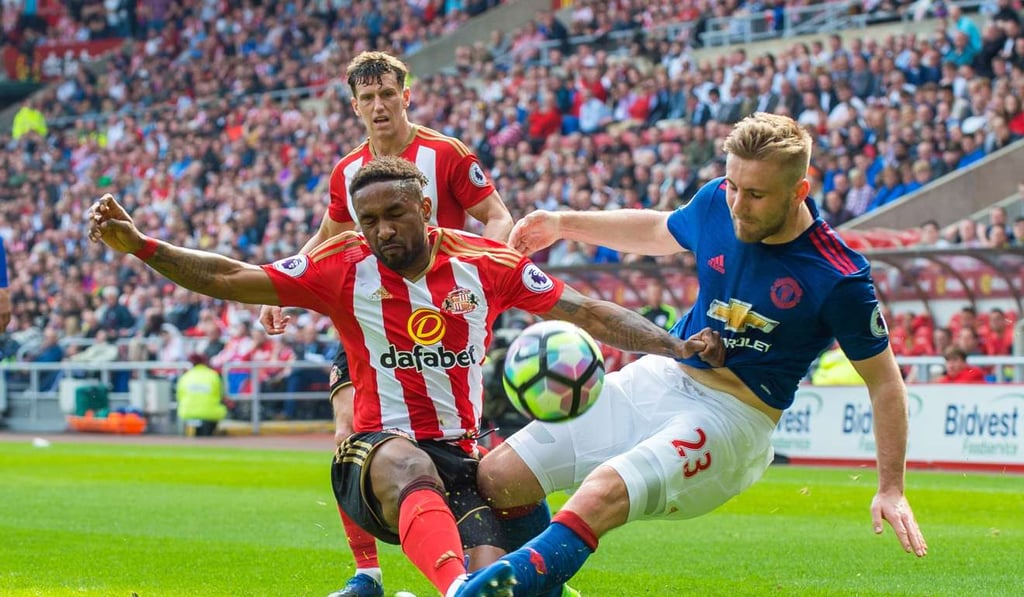 Luke Shaw goes in for a tackle with Jermain Defoe. Photo: EPA Luke Shaw goes in for a tackle with Jermain Defoe. Photo: EPA
